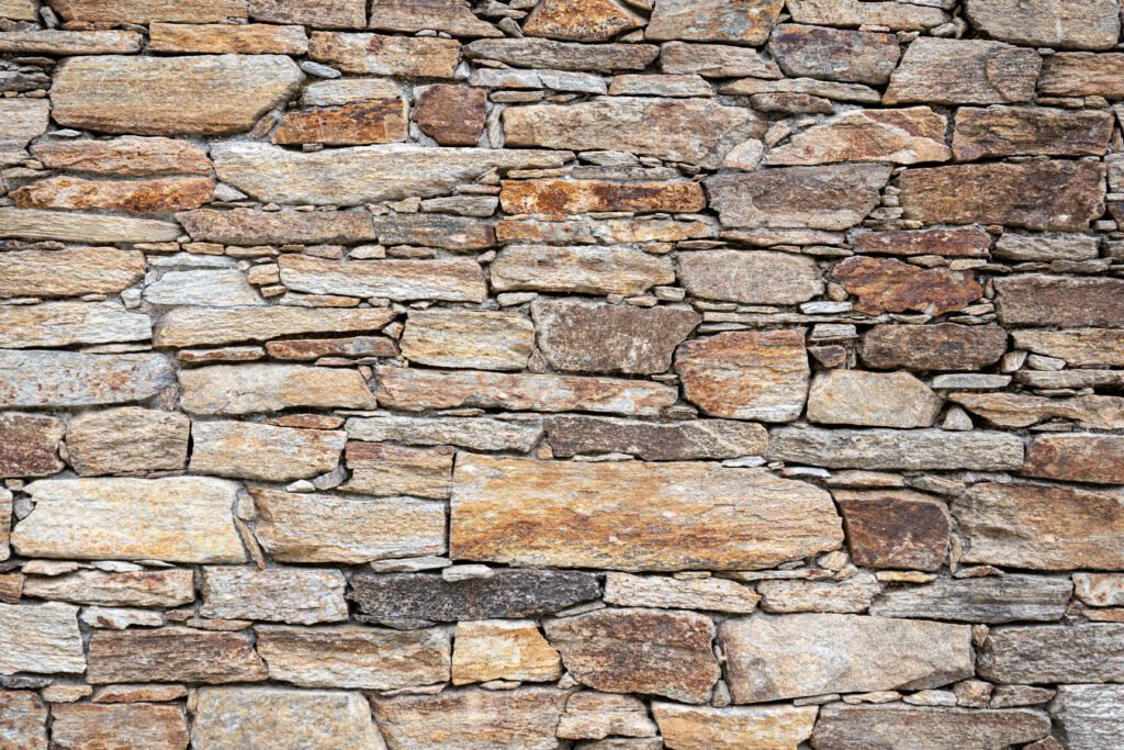 Dry masonry Stone wall background texture.