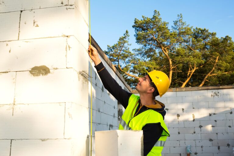 Engineer measuring wall.